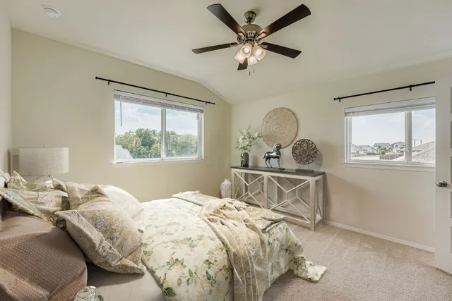 an empty room with wooden floor closet and windows