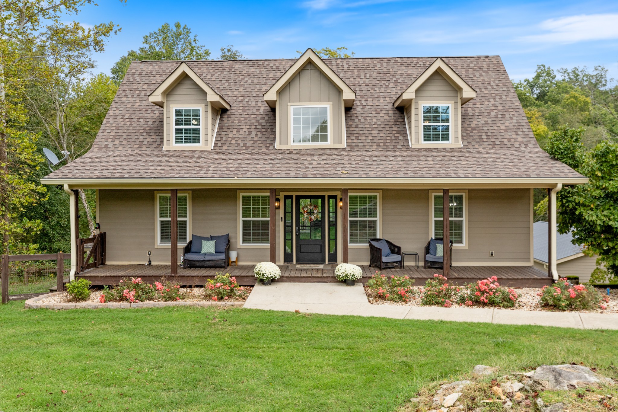a front view of a house with a garden and patio