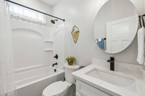 a bathroom with a sink a toilet and a mirror