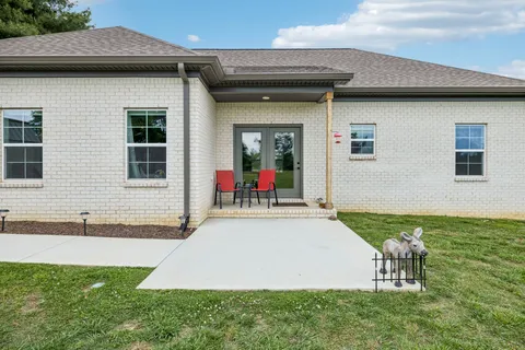 a view of a house with backyard and porch