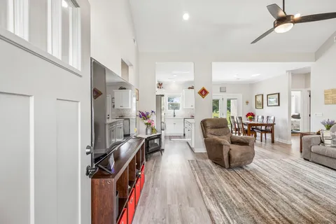 a living room with furniture wooden floor and a flat screen tv