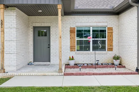 a front view of a house with a yard and a garage