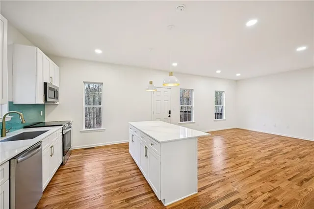 a bathroom with a sink mirror vanity and toilet