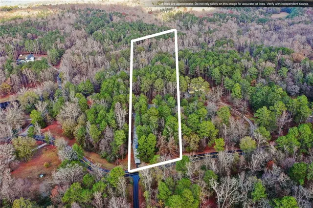 a view of an empty room with a window and a kitchen