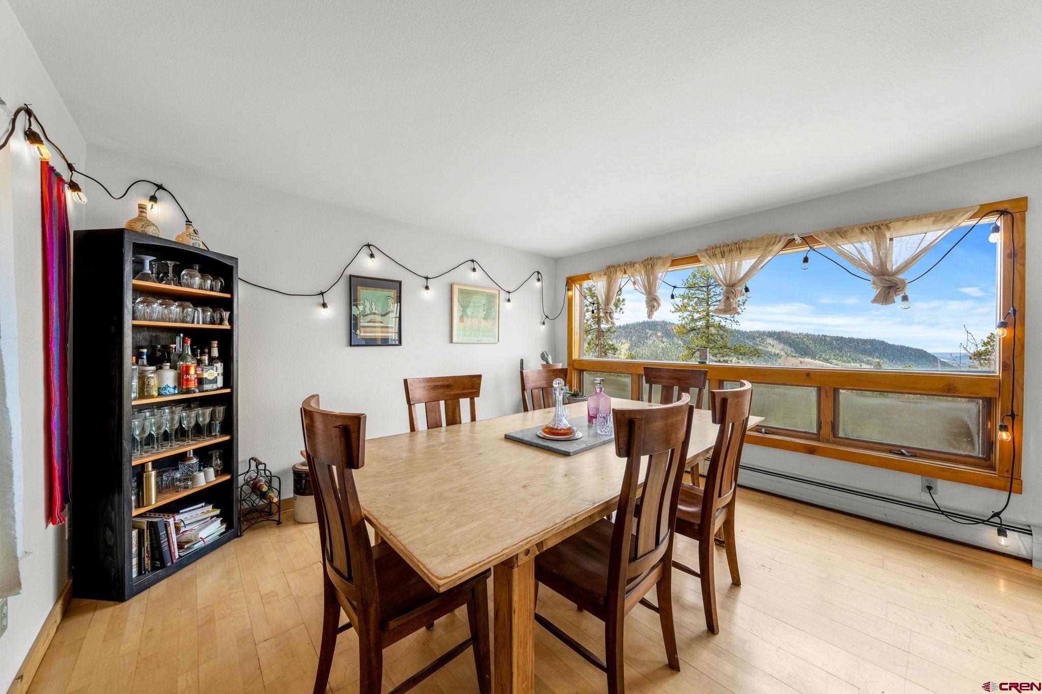 151 Sunny Lane Durango, CO 81301 - Photo 14 of 35 a view of a dining room with furniture window and wooden floor