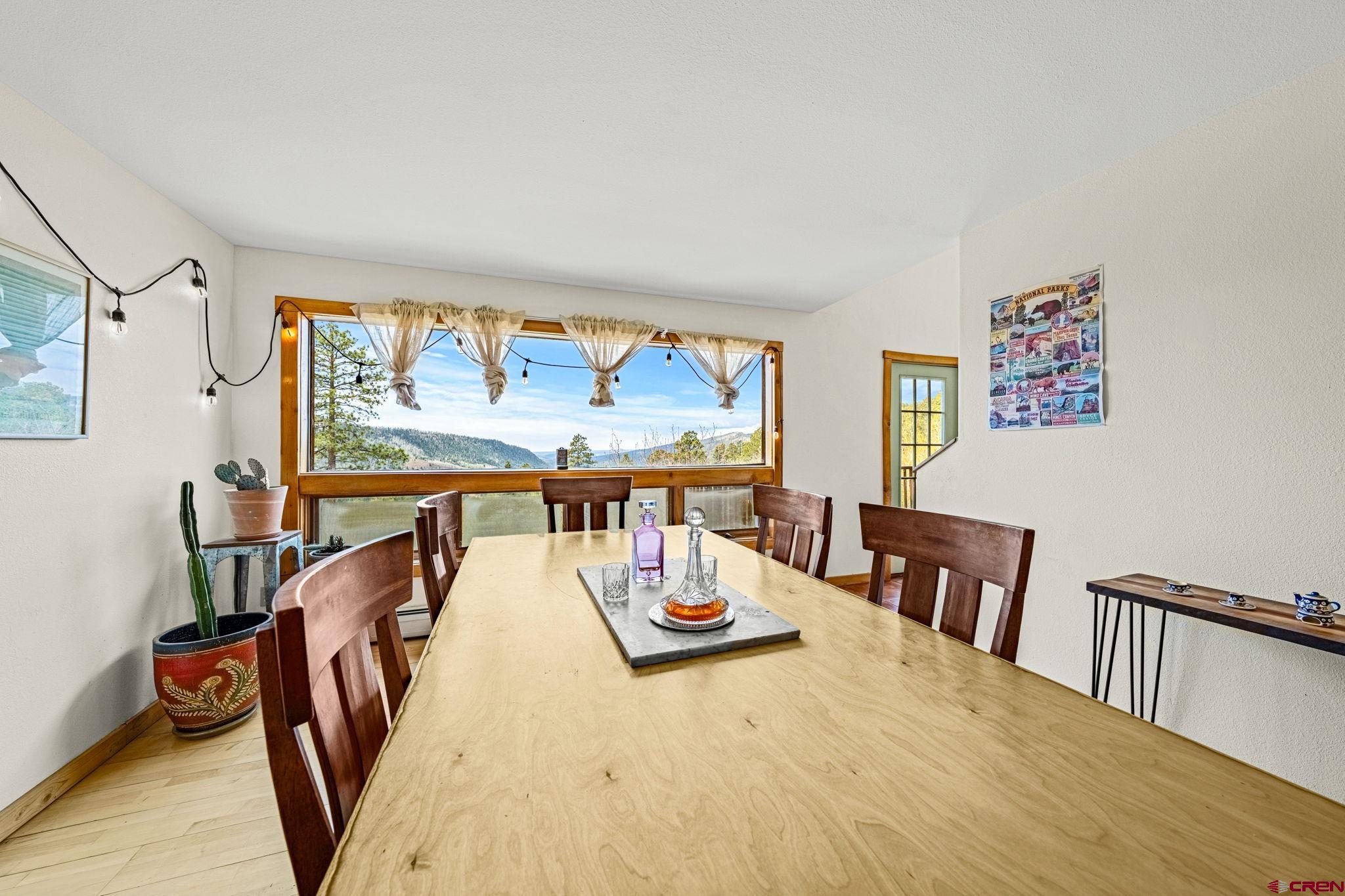 151 Sunny Lane Durango, CO 81301 - Photo 15 of 35 a view of a dining room with furniture window and wooden floor