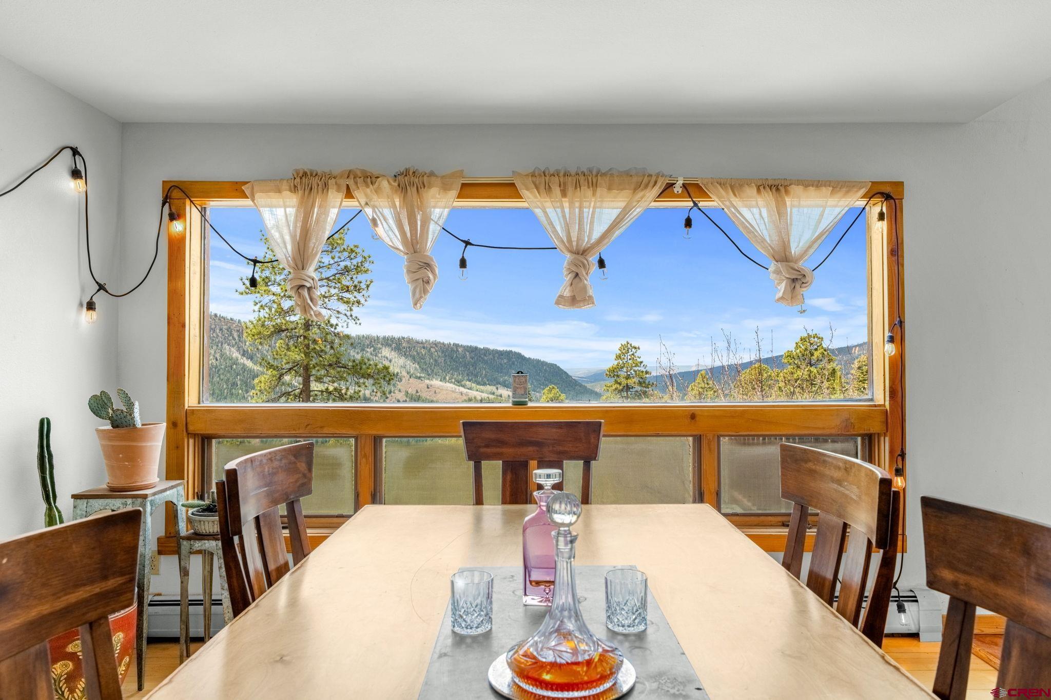 151 Sunny Lane Durango, CO 81301 - Photo 16 of 35 a view of a dining room with furniture a chandelier and wooden floor