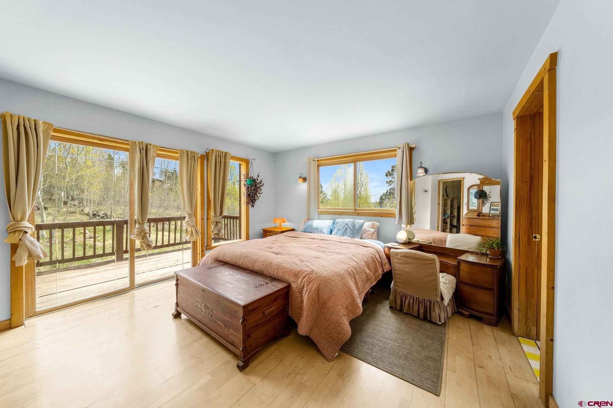 151 Sunny Lane Durango, CO 81301 - Photo 18 of 35 a spacious bedroom with a large bed and a large window