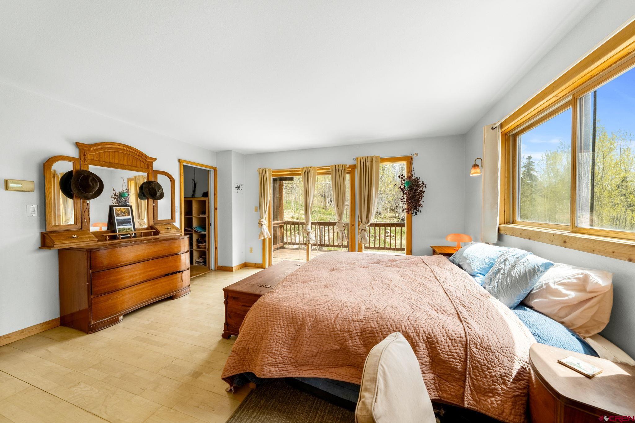 151 Sunny Lane Durango, CO 81301 - Photo 20 of 35 a bedroom with a bed and wooden floor