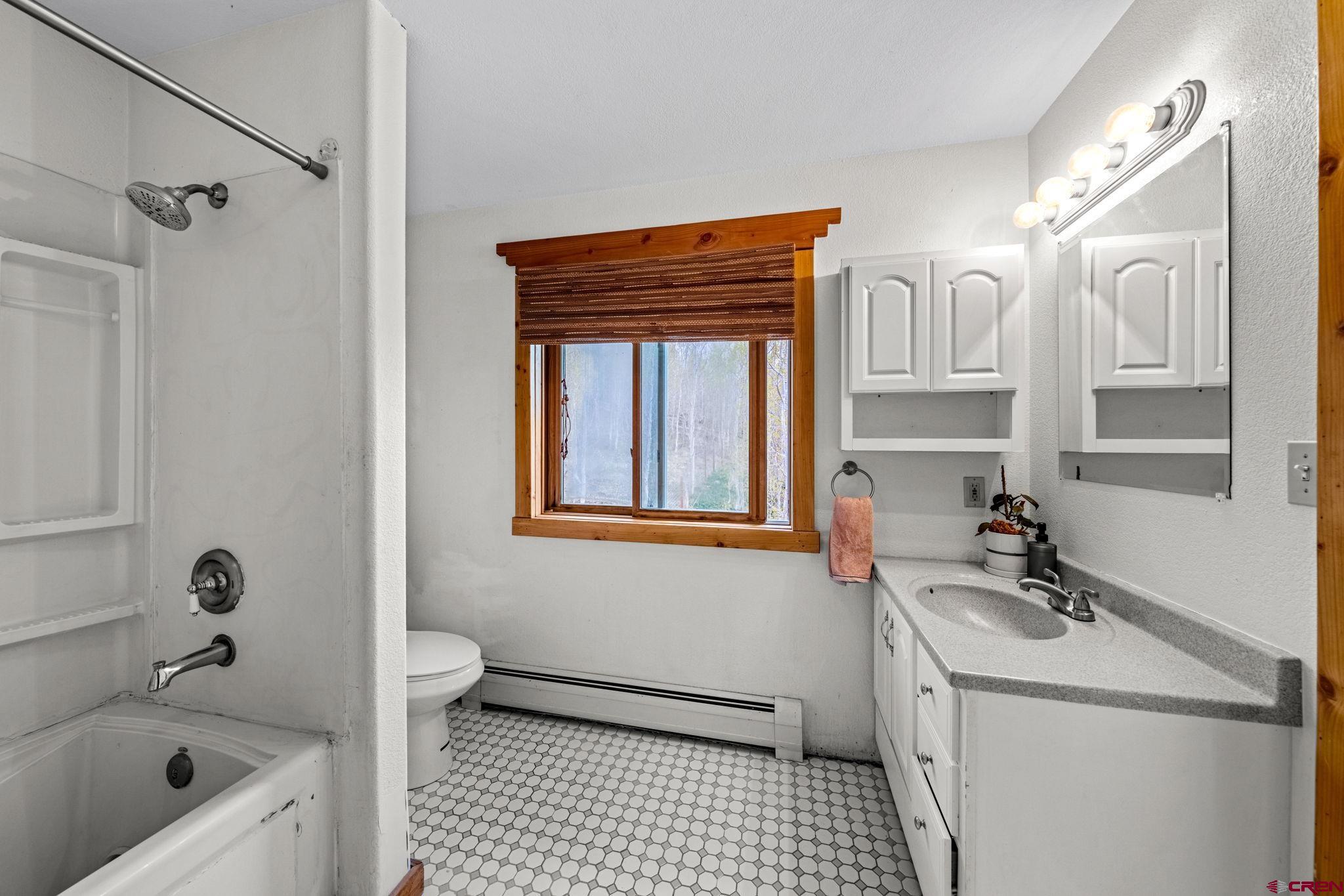 151 Sunny Lane Durango, CO 81301 - Photo 31 of 35 a bathroom with a bathtub a sink a toilet and a shower