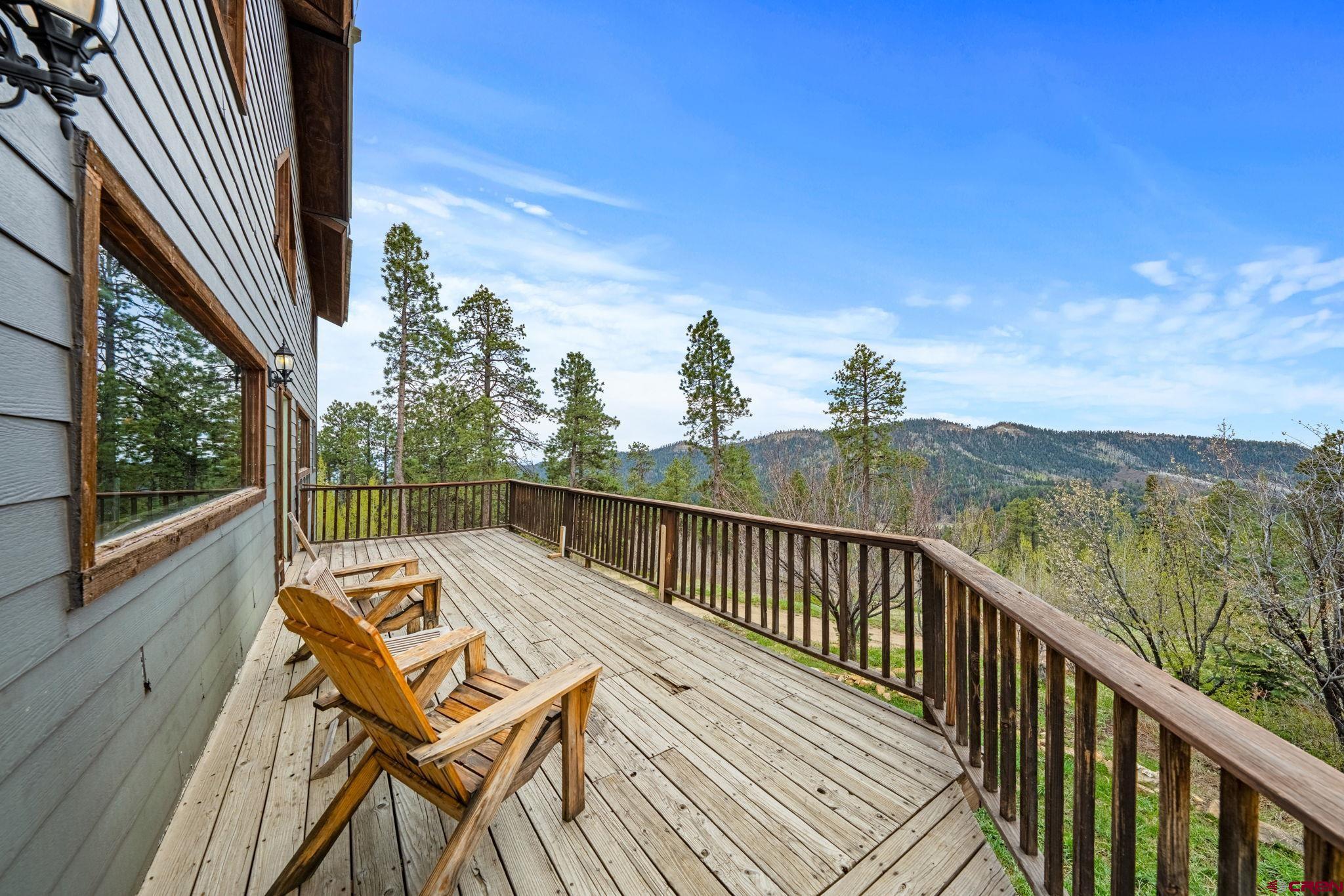 151 Sunny Lane Durango, CO 81301 - Photo 5 of 35 a view of a balcony with wooden floor and iron stairs