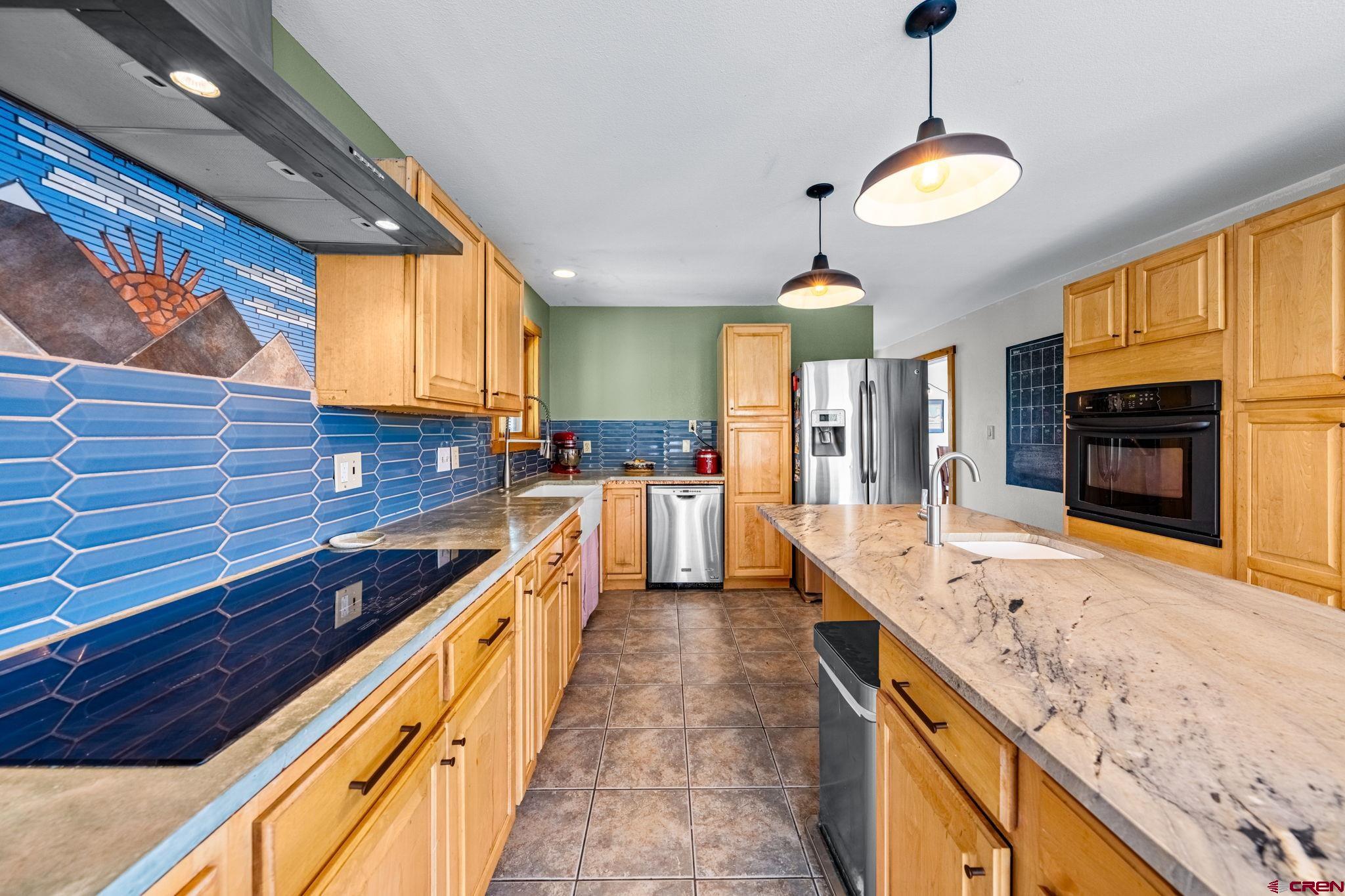 151 Sunny Lane Durango, CO 81301 - Photo 8 of 35 a large kitchen with stainless steel appliances granite countertop a sink and counter space
