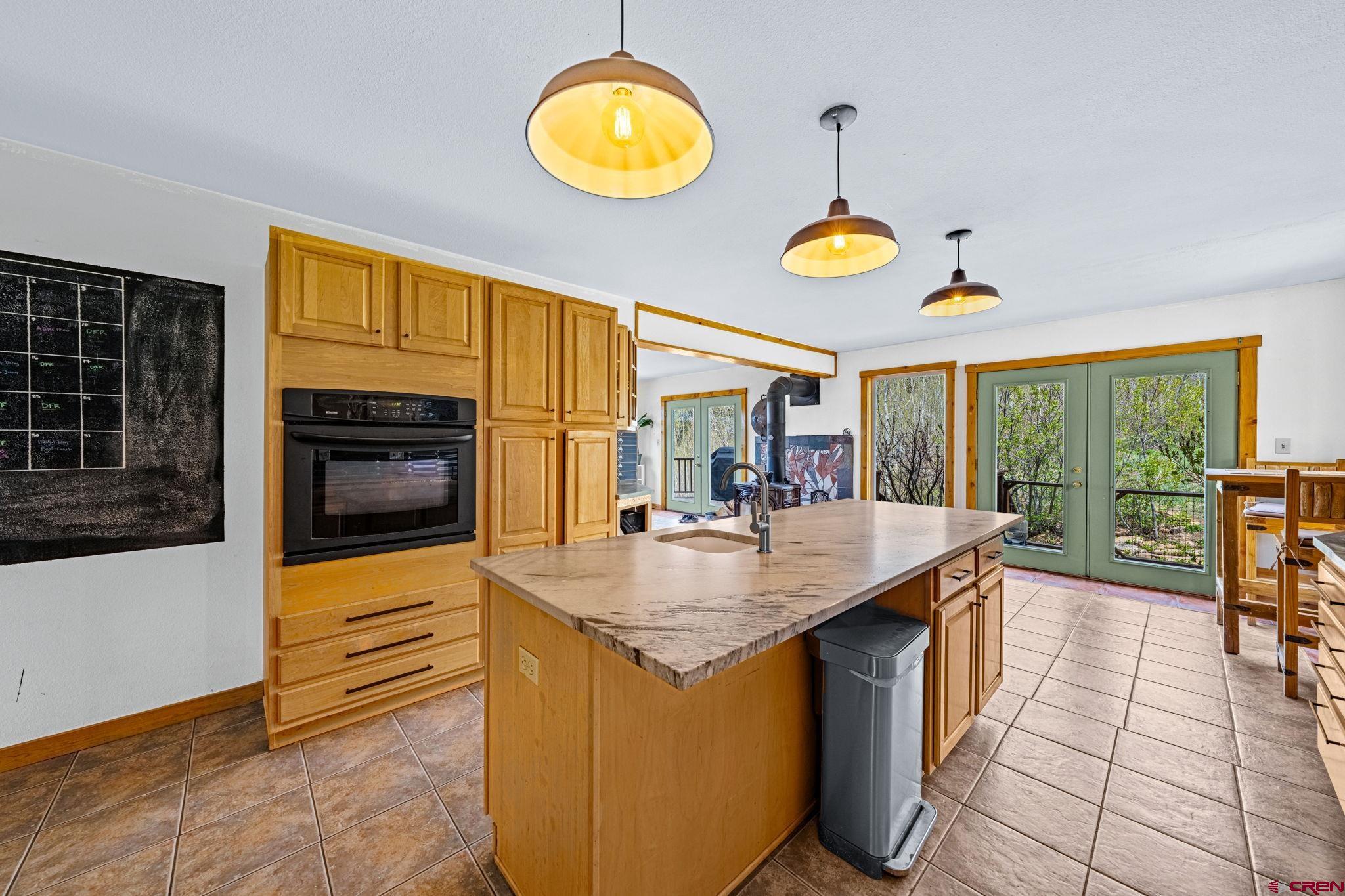 151 Sunny Lane Durango, CO 81301 - Photo 9 of 35 a kitchen with granite countertop counter top space a sink appliances and cabinets