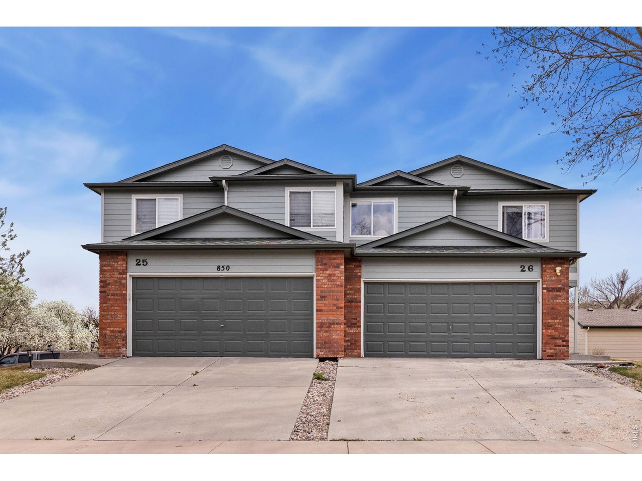 850 South Overland Trail, Unit 26 Fort Collins, CO 80521 - Photo 1 of 36 a front view of a house with a yard and garage