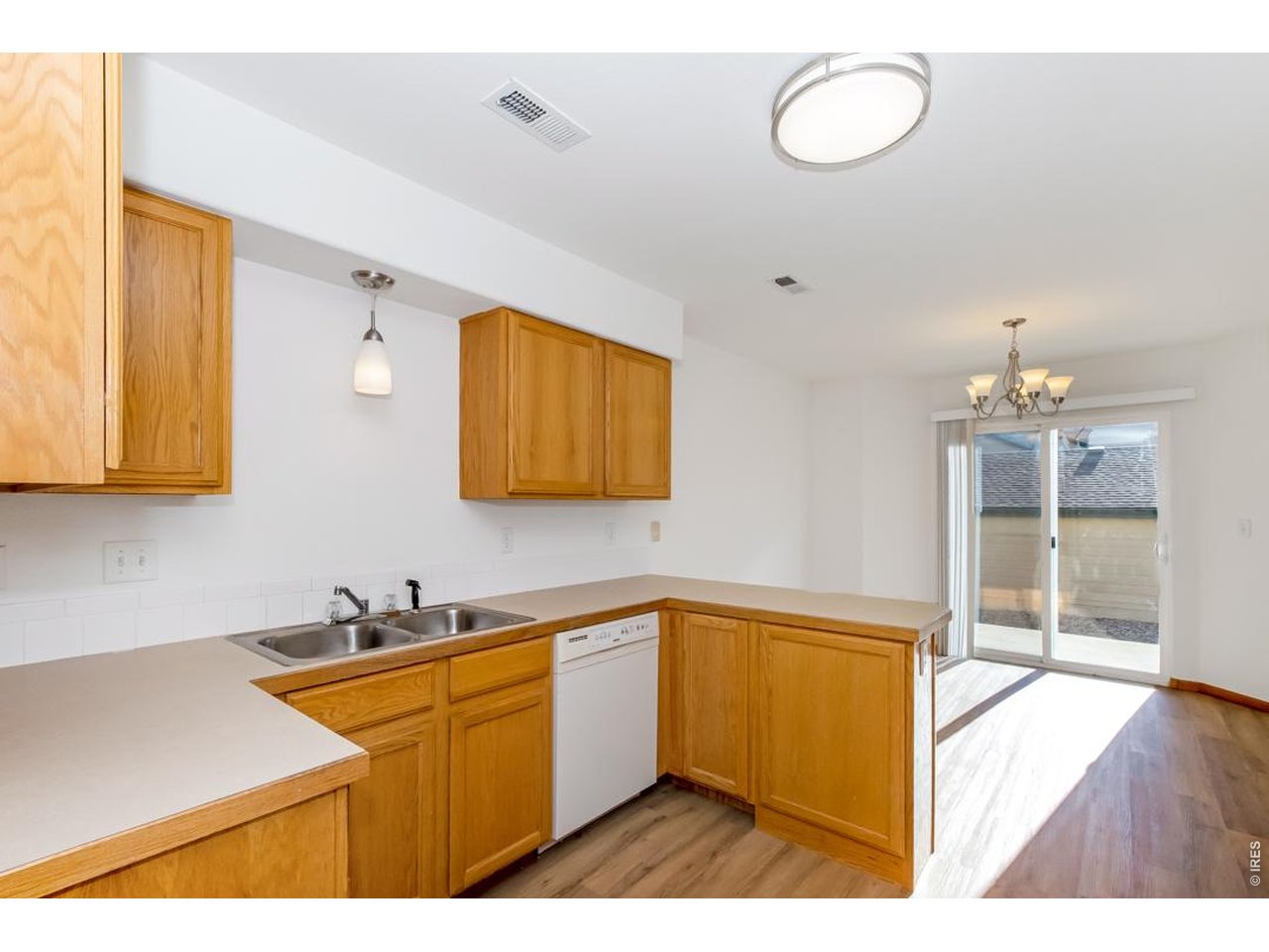 850 South Overland Trail, Unit 26 Fort Collins, CO 80521 - Photo 12 of 36 a kitchen with granite countertop a sink cabinets and stainless steel appliances