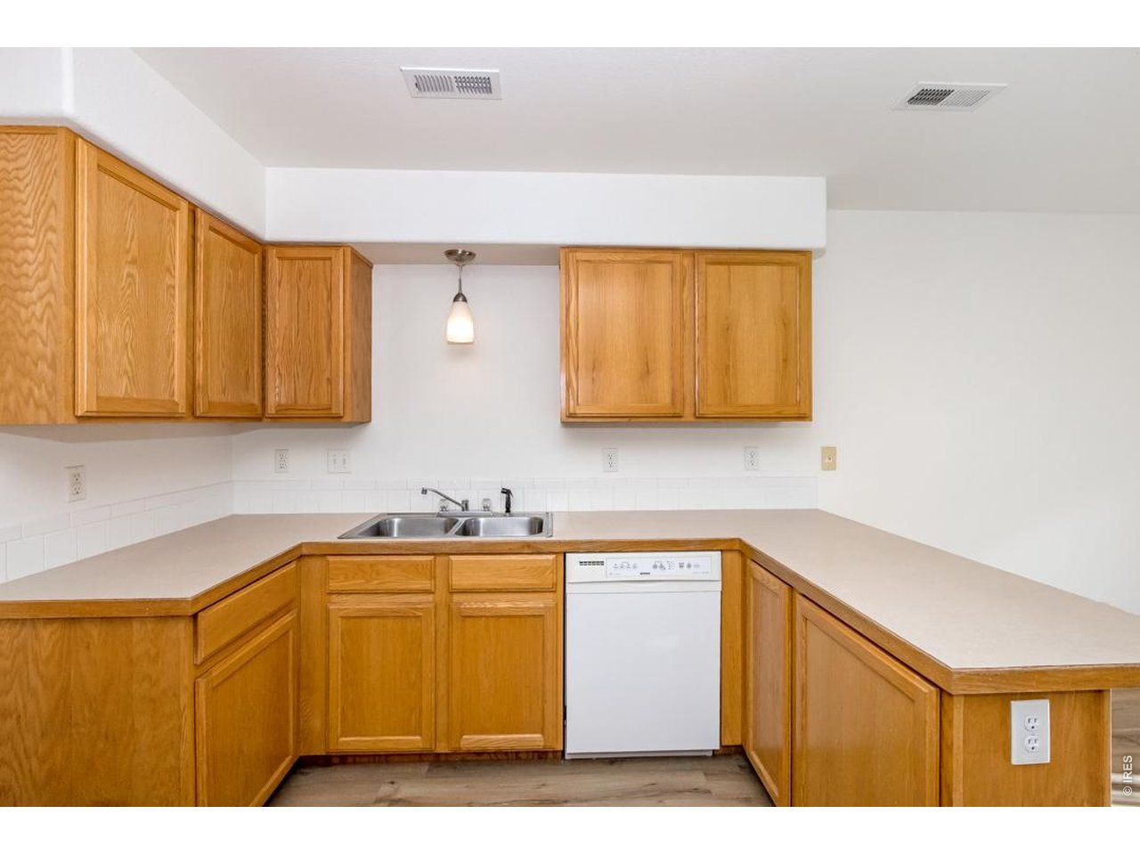 850 South Overland Trail, Unit 26 Fort Collins, CO 80521 - Photo 13 of 36 a kitchen with a sink cabinets and a wooden floor