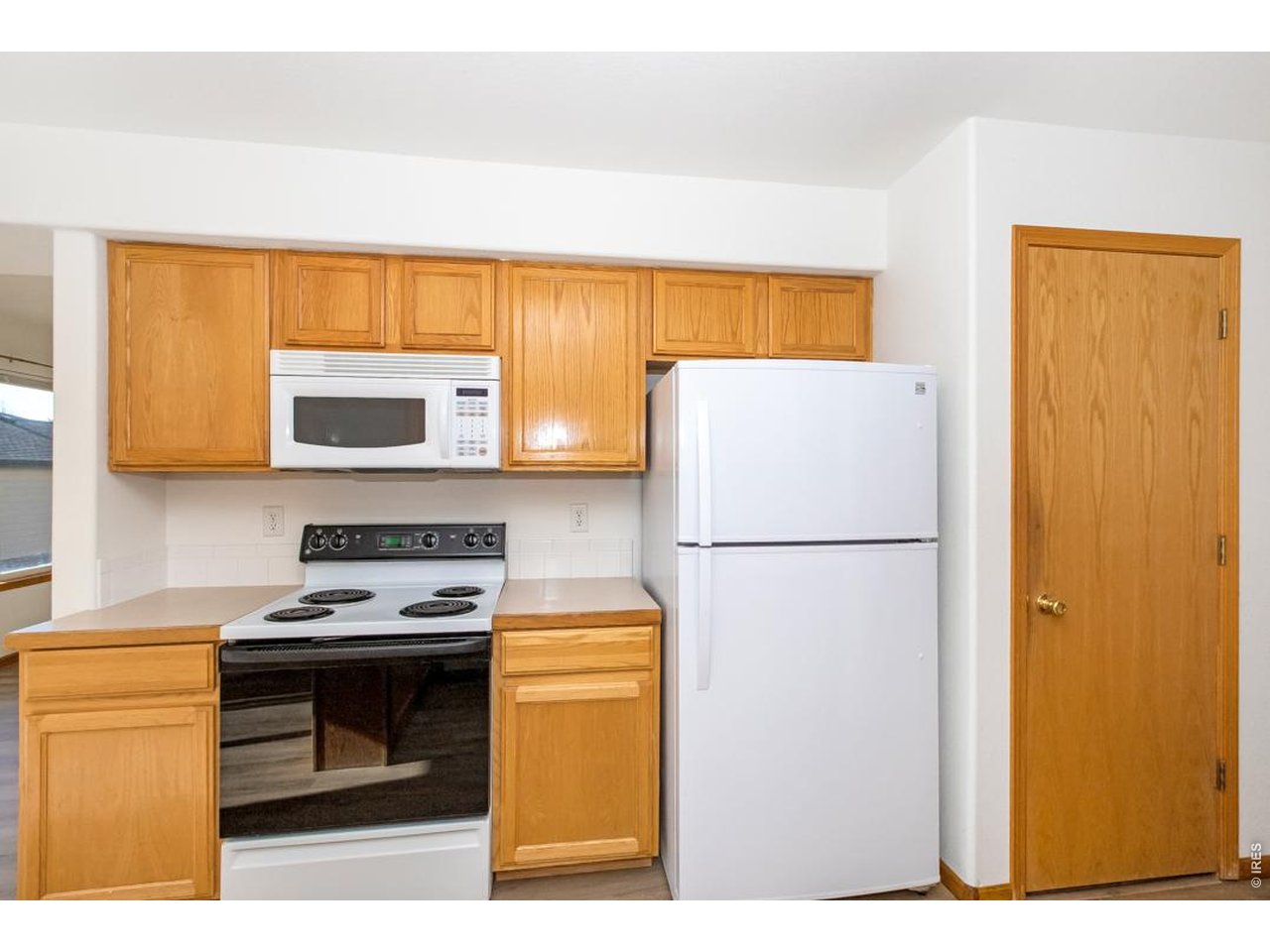 850 South Overland Trail, Unit 26 Fort Collins, CO 80521 - Photo 15 of 36 a kitchen with a refrigerator a stove top oven
