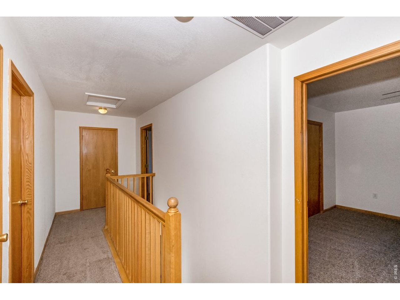 850 South Overland Trail, Unit 26 Fort Collins, CO 80521 - Photo 23 of 36 a view of a hallway with wooden floor and staircase