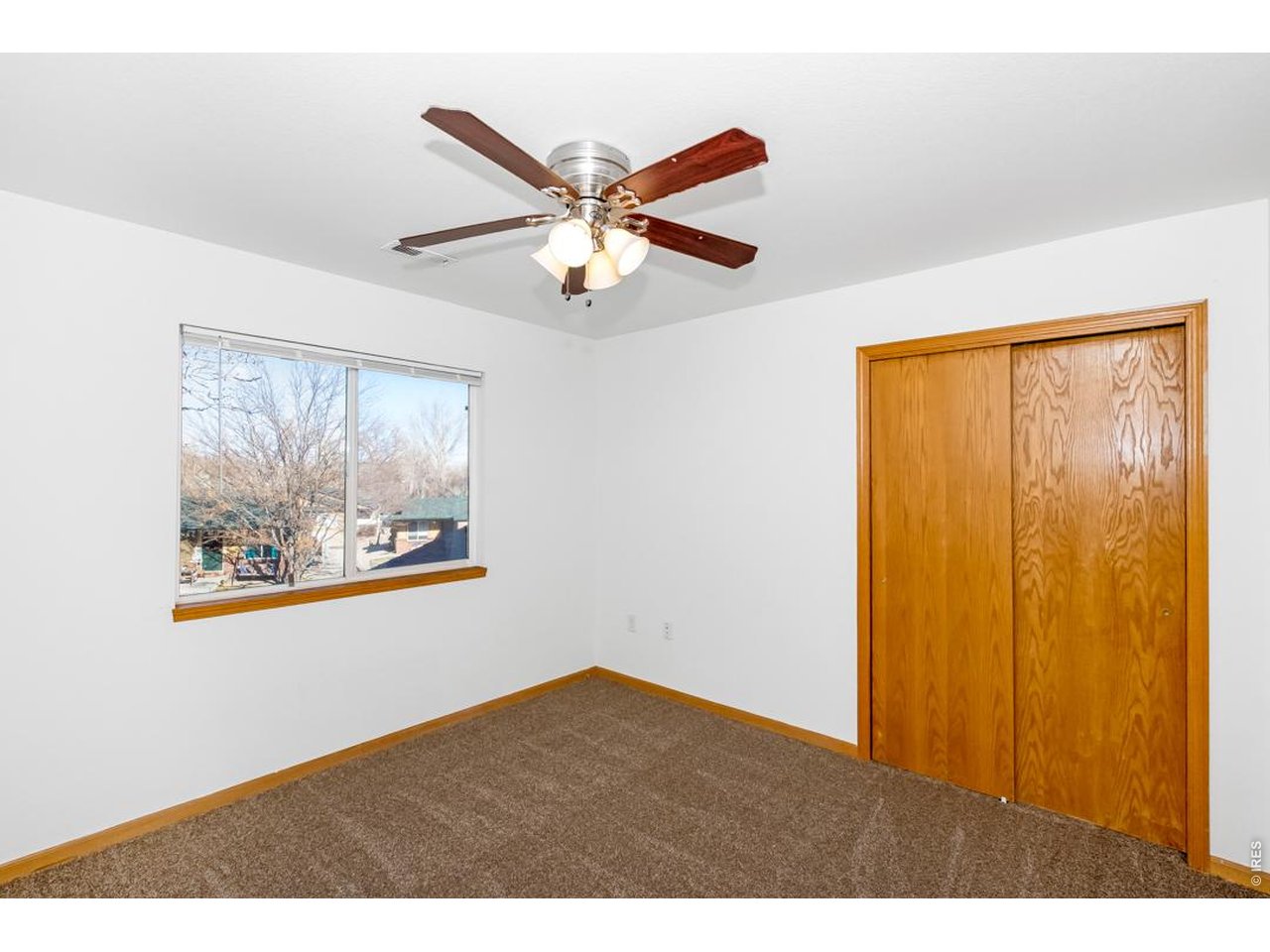 850 South Overland Trail, Unit 26 Fort Collins, CO 80521 - Photo 24 of 36 a view of an empty room with window and a ceiling fan