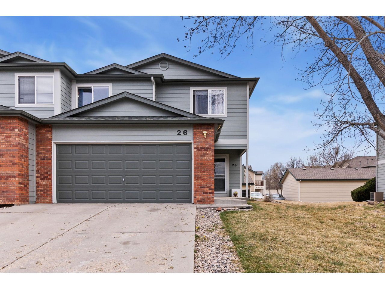 850 South Overland Trail, Unit 26 Fort Collins, CO 80521 - Photo 3 of 36 a front view of a house with a yard