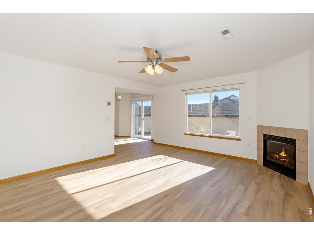 850 South Overland Trail, Unit 26 Fort Collins, CO 80521 - Photo 7 of 36 a view of an empty room with a fireplace and wooden floor