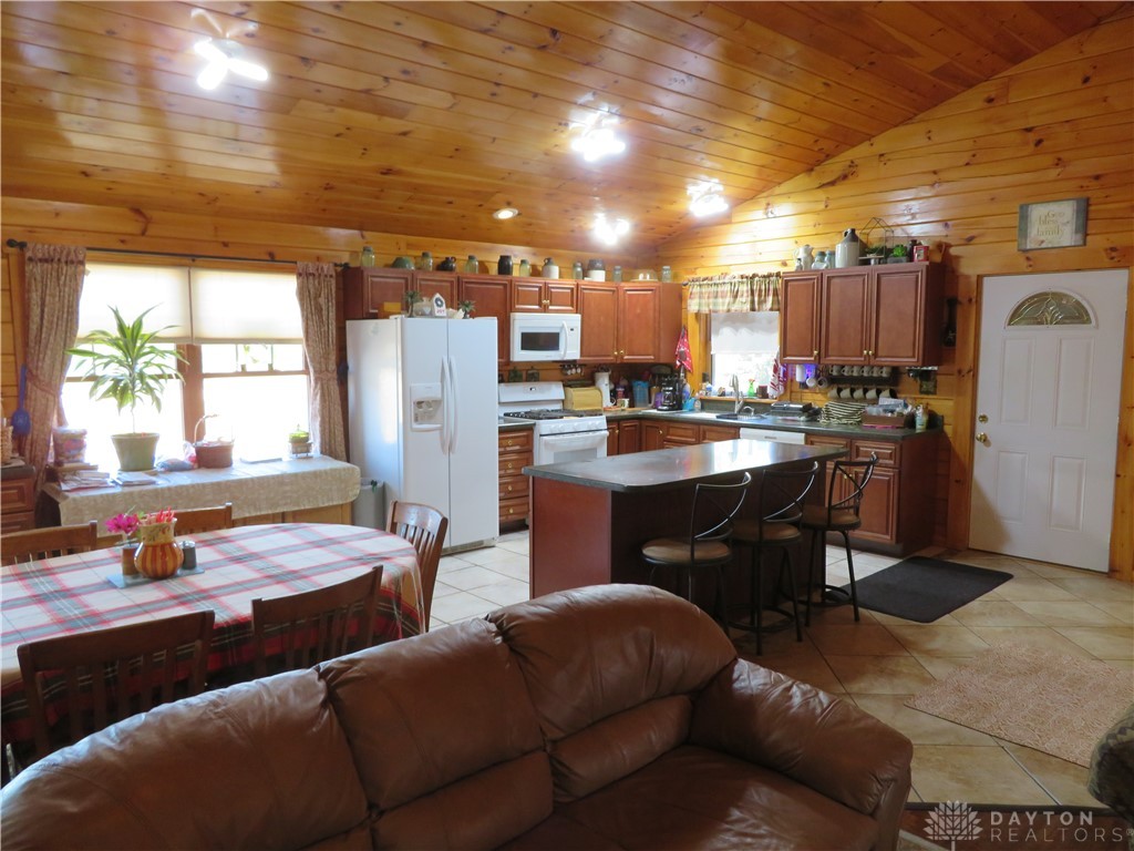 748 Inlow Avenue Peebles, OH 45660 - Photo 12 of 61 Warm wood accents create an inviting atmosphere in this open-concept kitchen and dining area.
