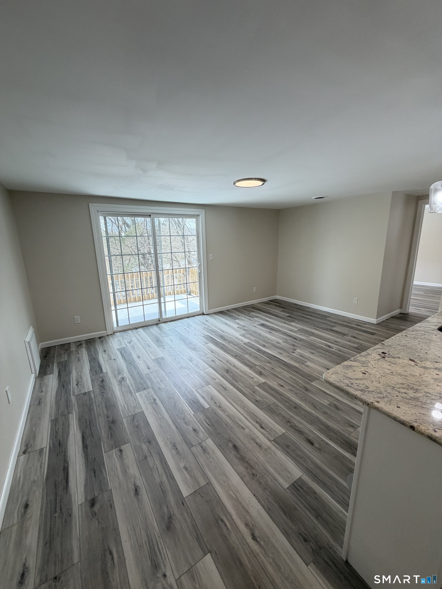 267 Branford Road, Unit 203 North Branford, CT 06471 - Photo 2 of 7 an empty room with wooden floor and windows