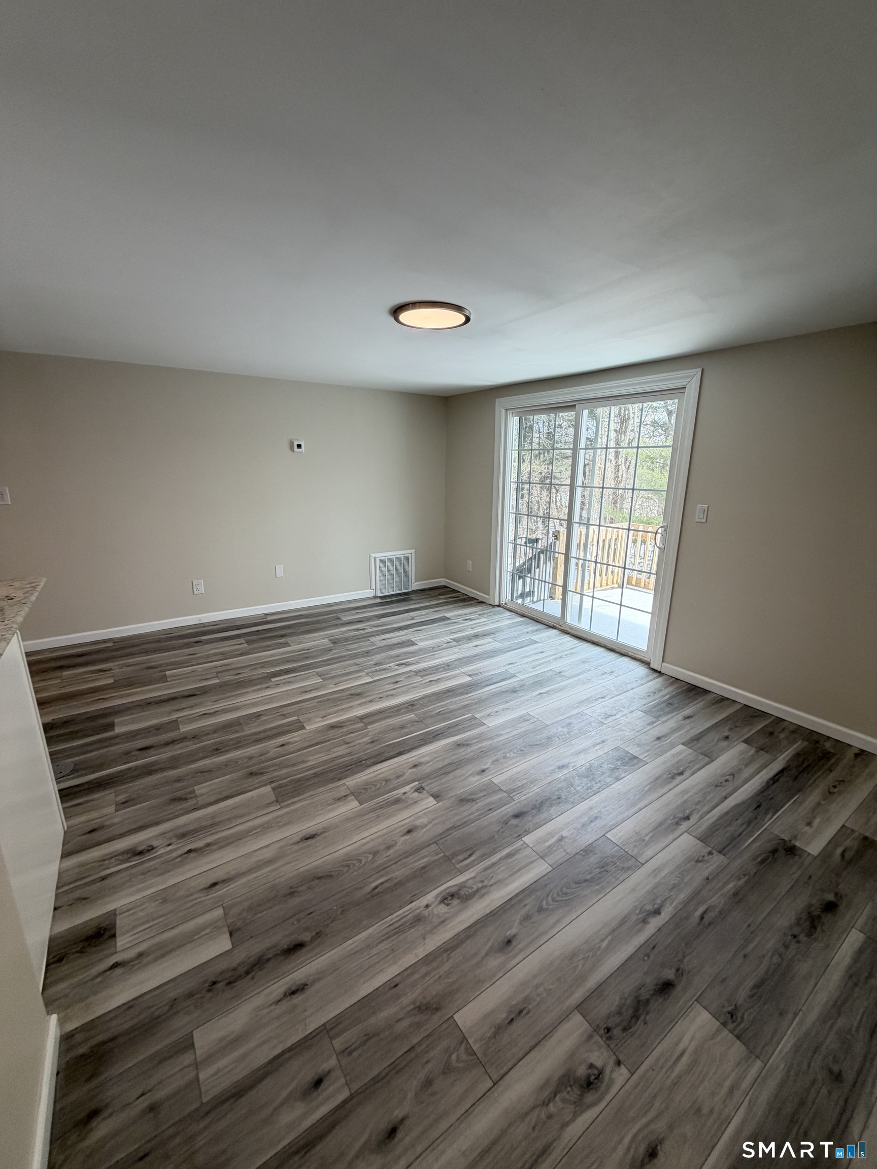 267 Branford Road, Unit 203 North Branford, CT 06471 - Photo 3 of 7 a view of an empty room with wooden floor and a window