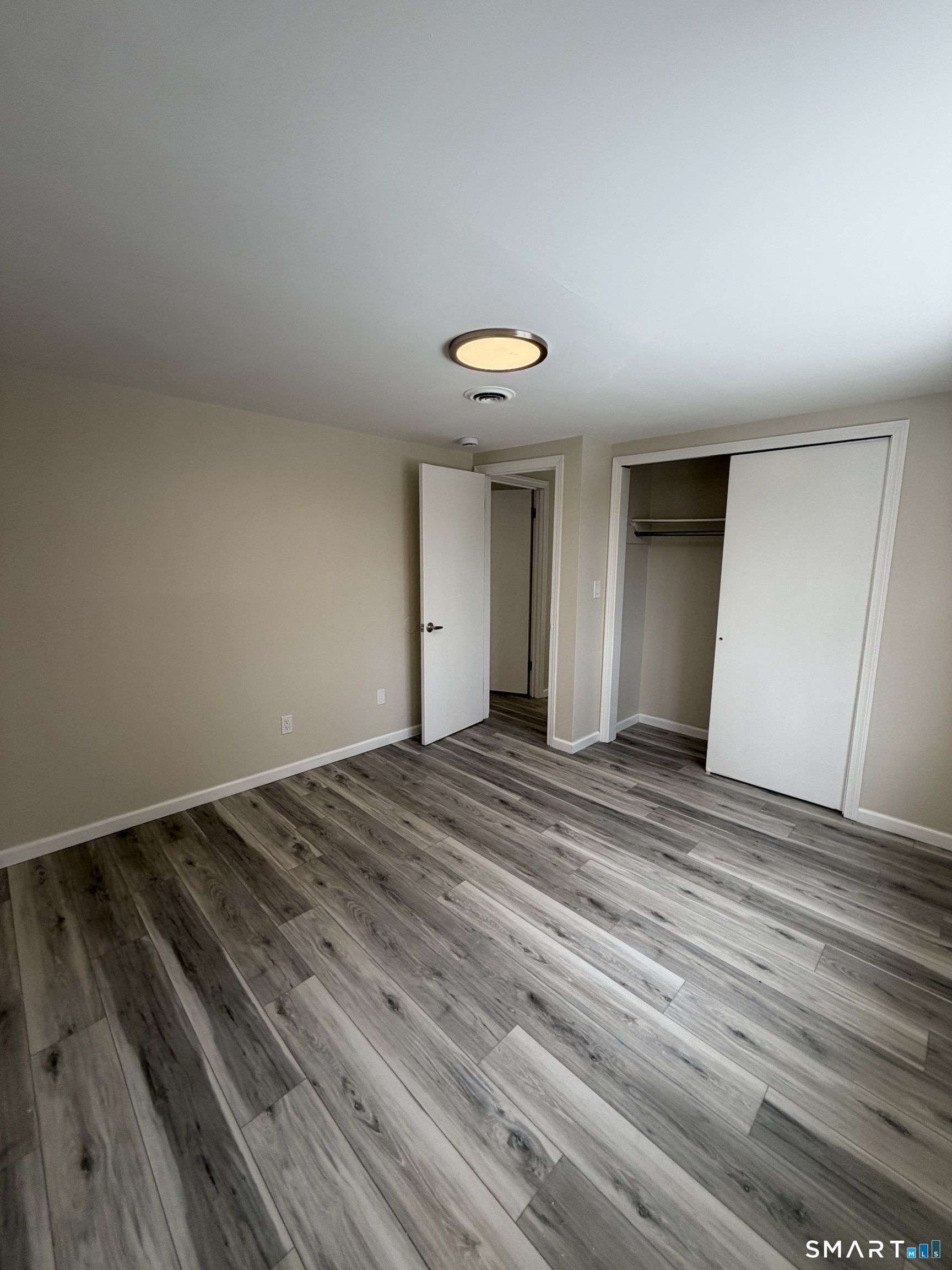 267 Branford Road, Unit 203 North Branford, CT 06471 - Photo 5 of 7 a view of a room with wooden floor and ceiling fan