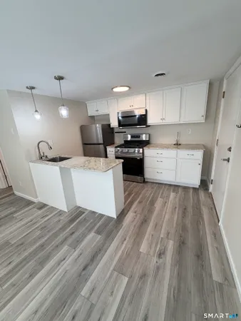 a large white kitchen with cabinets