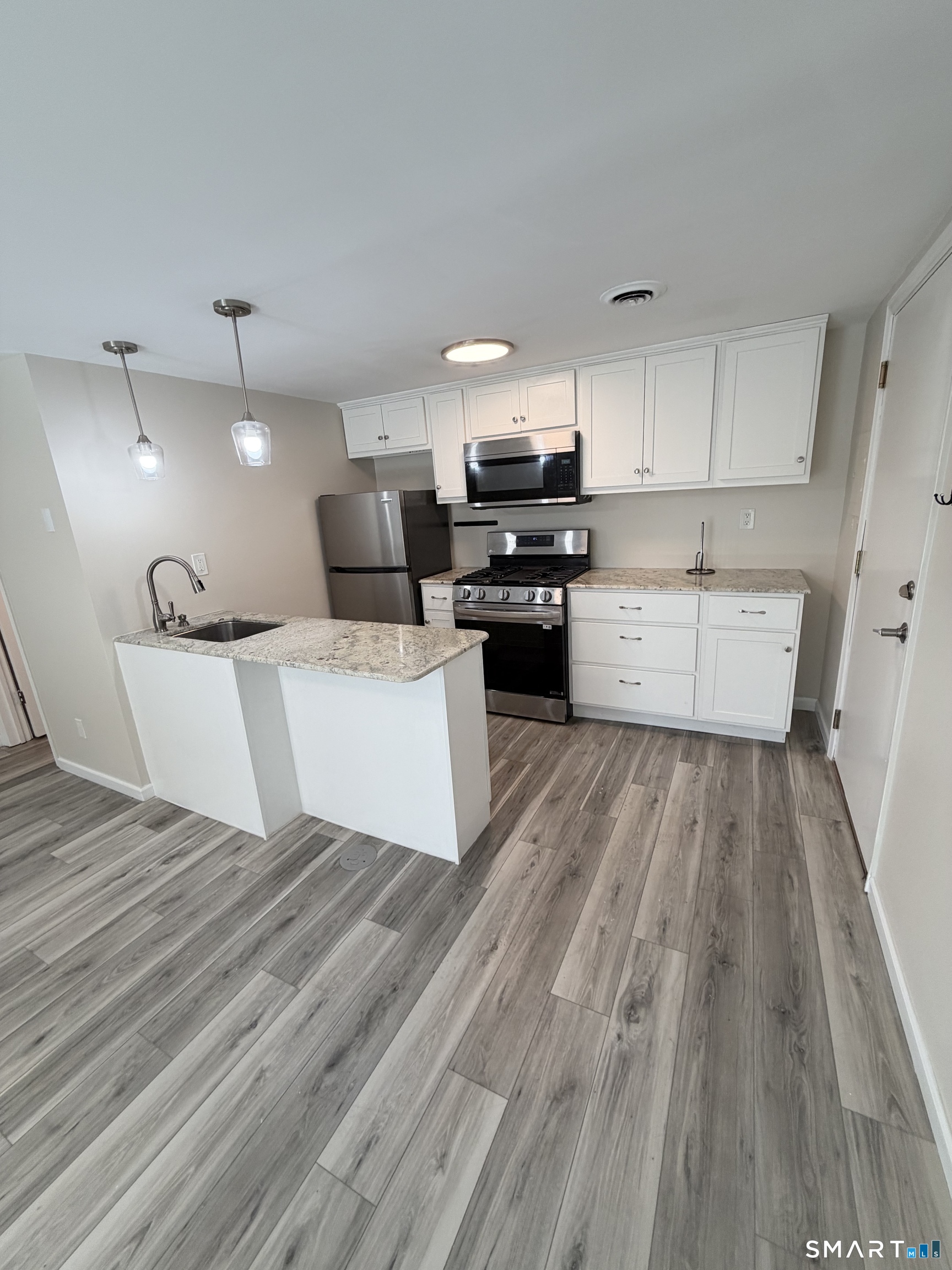 267 Branford Road, Unit 203 North Branford, CT 06471 - Photo 6 of 7 a large white kitchen with cabinets