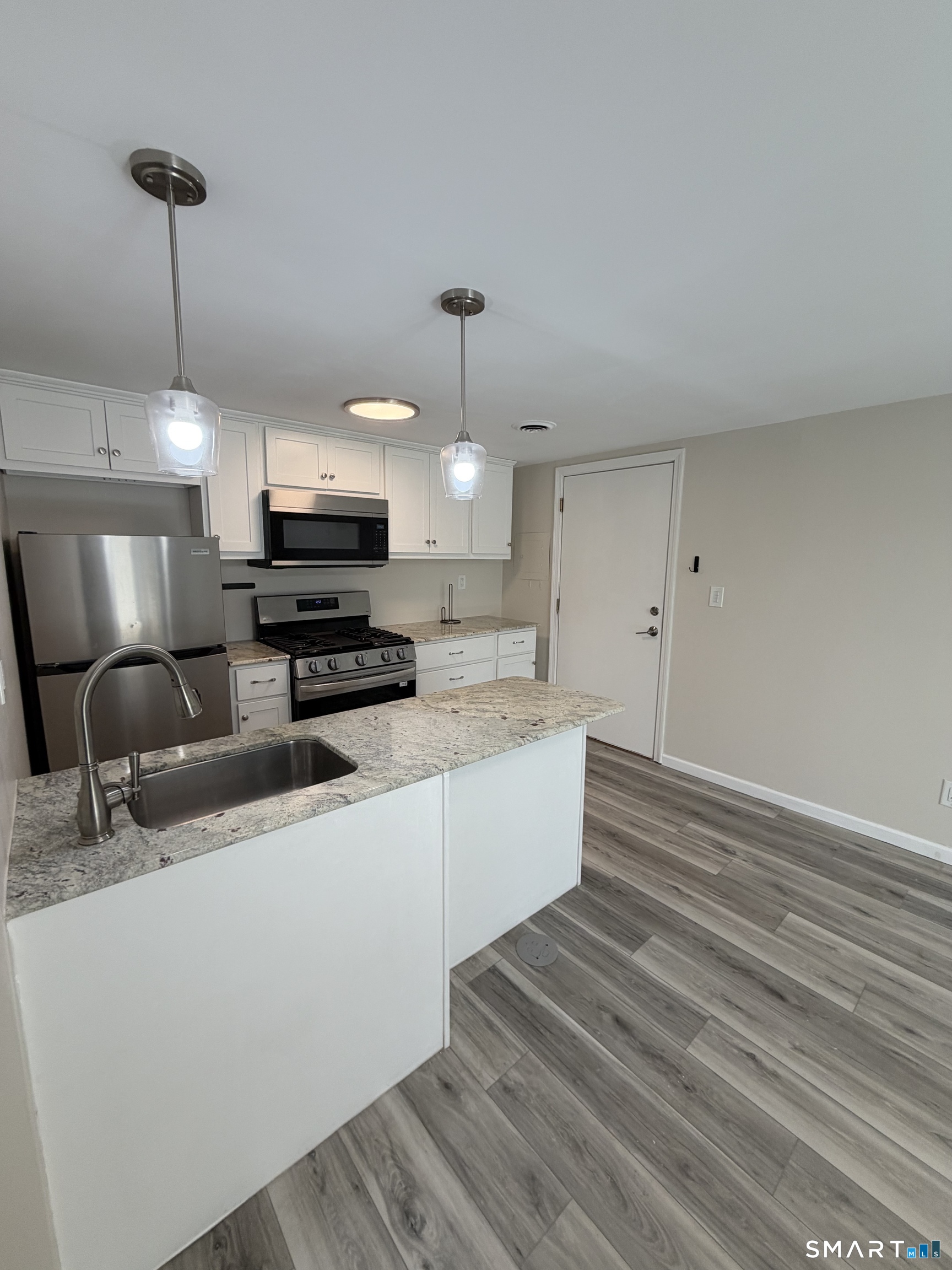 267 Branford Road, Unit 203 North Branford, CT 06471 - Photo 7 of 7 a large kitchen with kitchen island a sink stainless steel appliances and cabinets