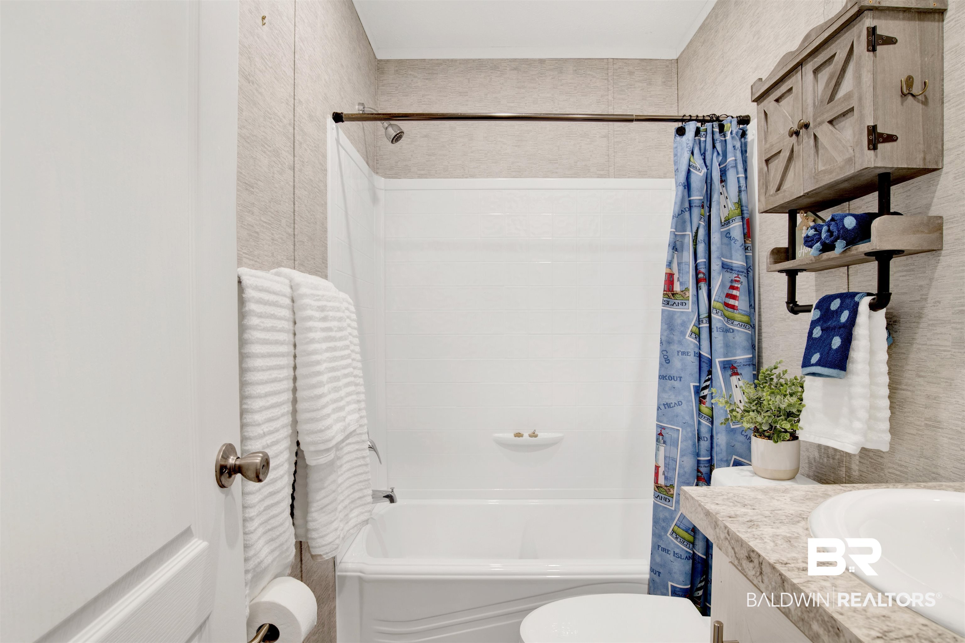 1411 Ridgewood Drive Lillian, AL 36549 - Photo 25 of 30 Full bathroom featuring shower / tub combo with curtain, vanity, and toilet