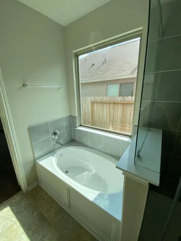 a bath tub sitting next to a window