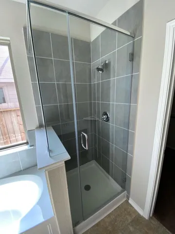 a bathroom with a shower and a tub