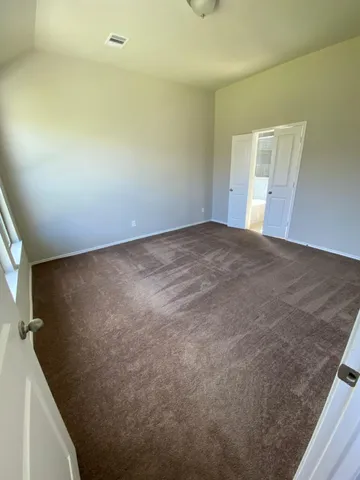 a view of a big room with closet and windows