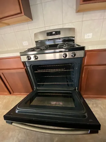 a stove top oven sitting inside of a kitchen