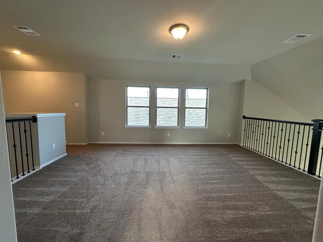 a view of an empty room and a window