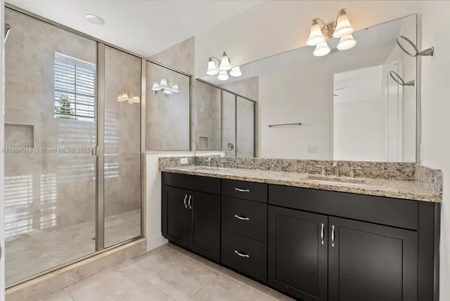a bathroom with a granite countertop sink a toilet and a mirror