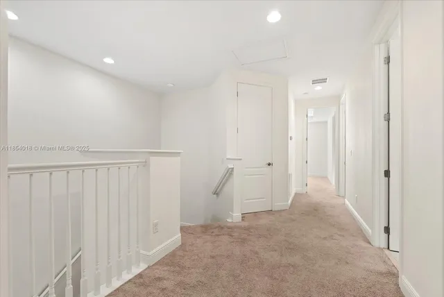 an empty room with a window and a chandelier fan