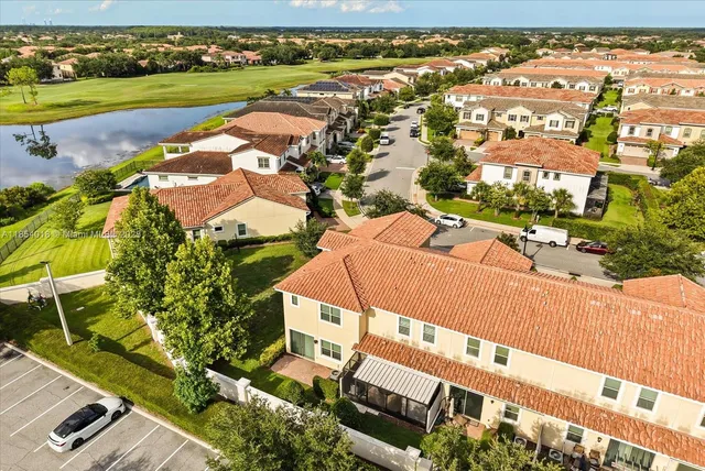 an aerial view of a residential houses with yard