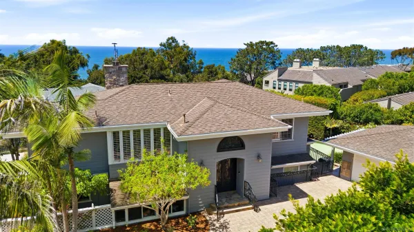 a aerial view of a house with a yard and potted plants