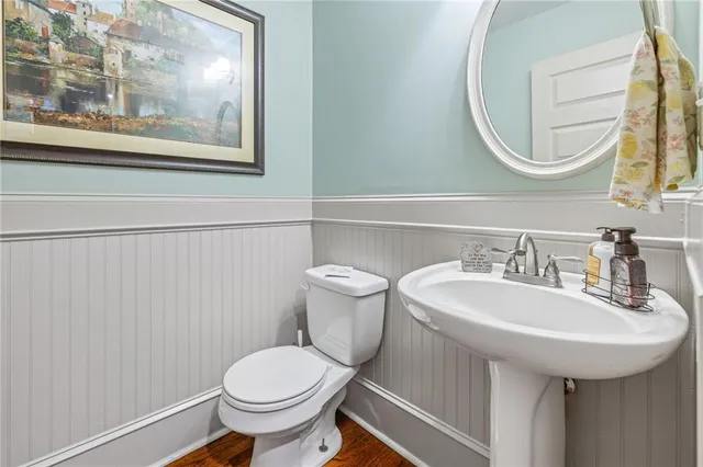 a bathroom with a toilet a sink and a mirror