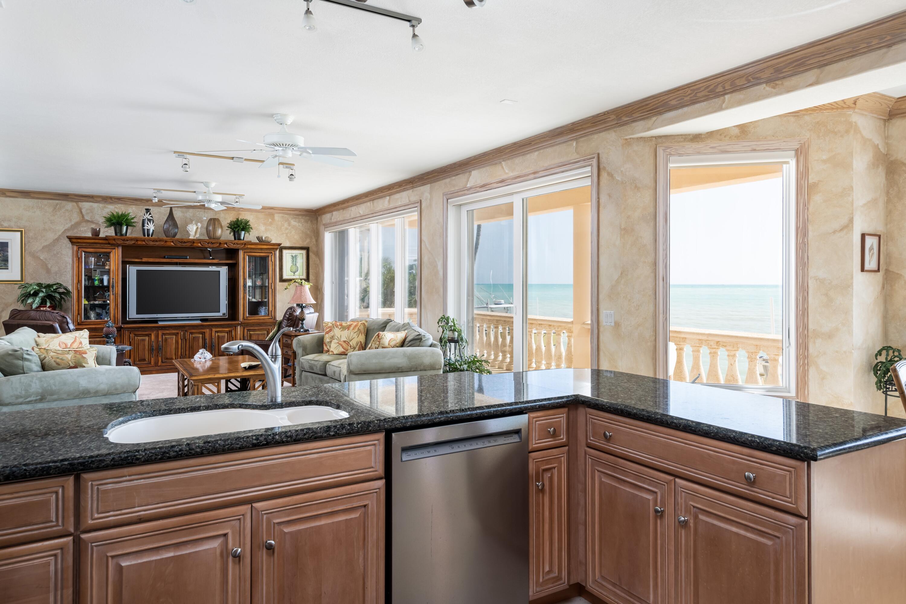 5 Ocean Drive East Marathon, FL 33050 - Photo 18 of 79 a kitchen with stainless steel appliances granite countertop a sink a stove and a window