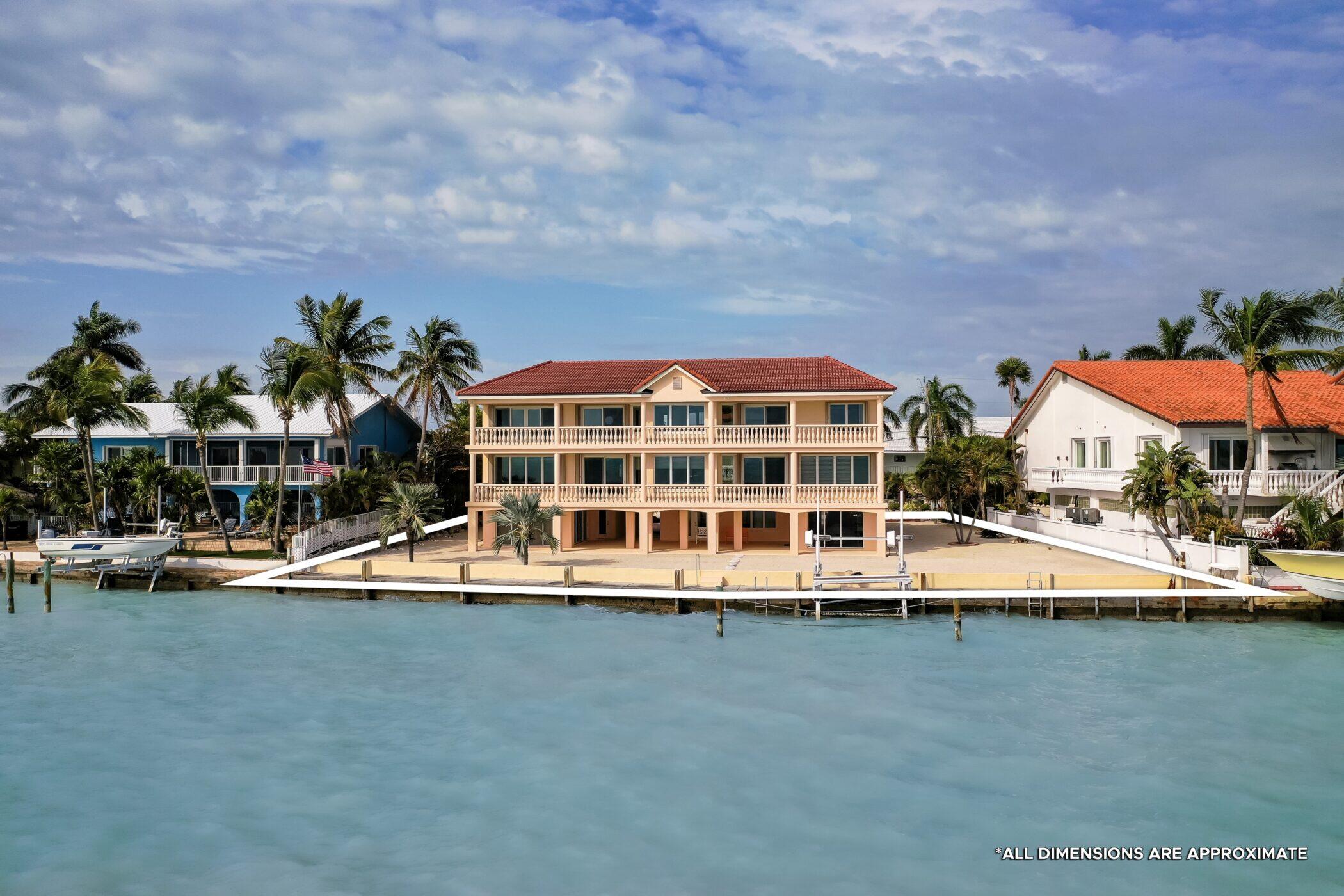 5 Ocean Drive East Marathon, FL 33050 - Photo 66 of 79 a view of a swimming pool with lawn chairs and plants