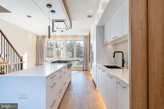 a white stove top oven sitting inside of a kitchen
