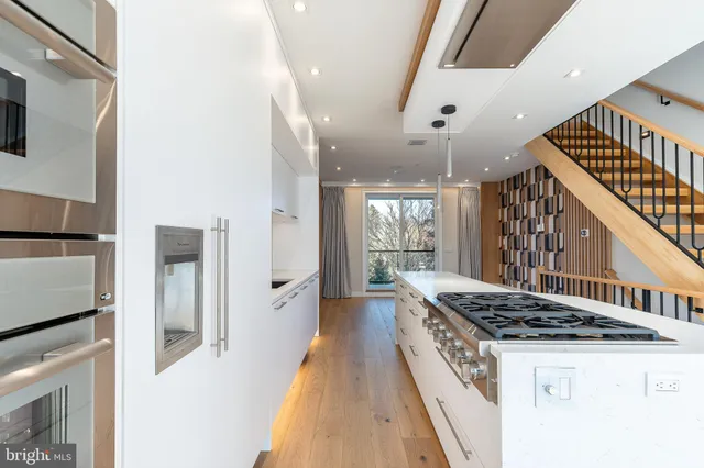 a close view of a sink and dishwasher in a white cabinet