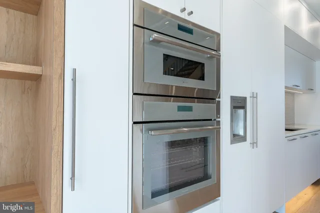a view of staircase with white walls and a window