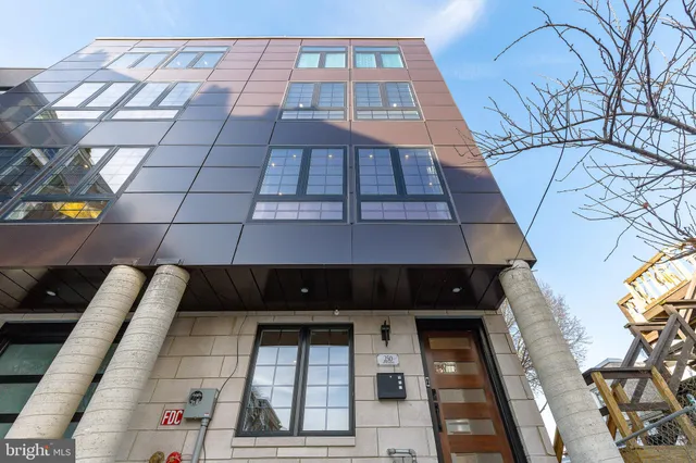 a view of a big room with wooden floor and windows