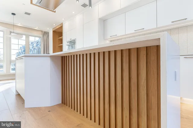 a view of a hallway with wooden floor and stairs